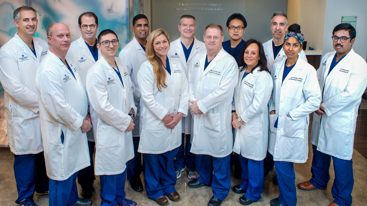 group photo of cardiology providers in white lab coats and blue scrubs