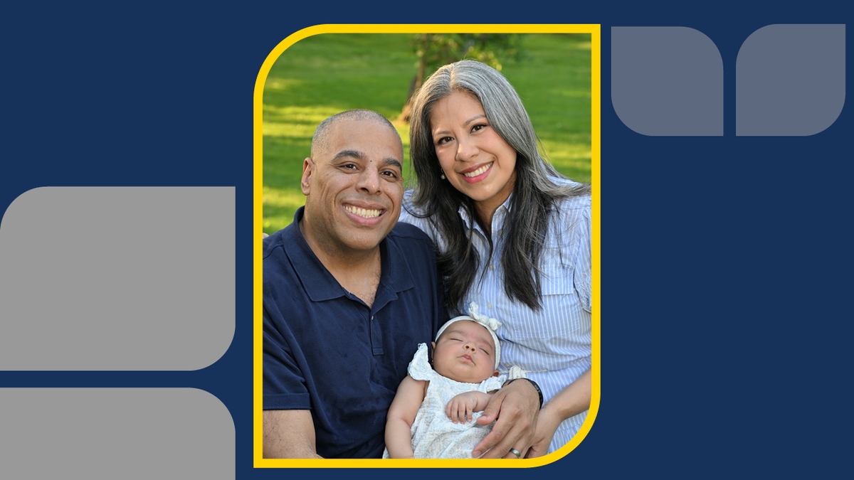 A portrait of a couple with their newborn baby in an outdoor setting with headline Strength for Two
